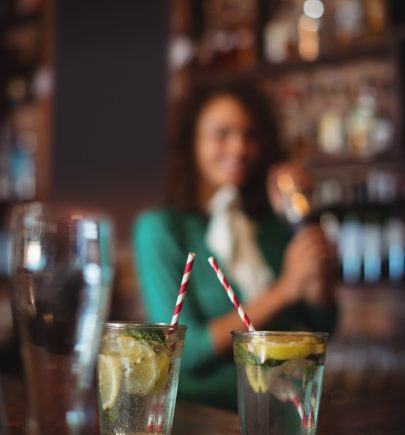 Two glasses of cocktail on worktop at bar counter